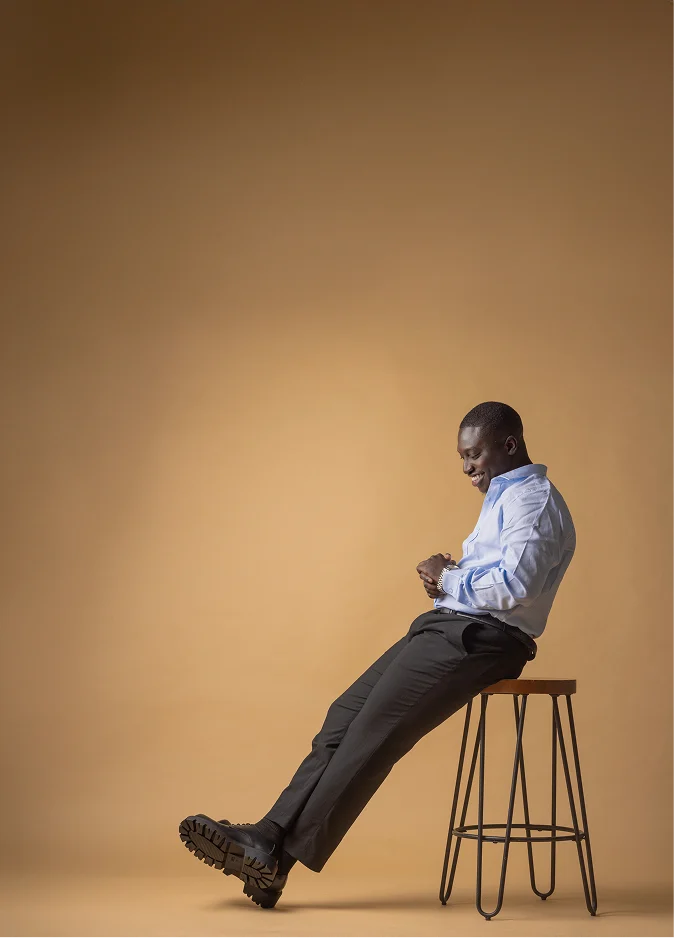 Iseunife Ajayi sitting on stool